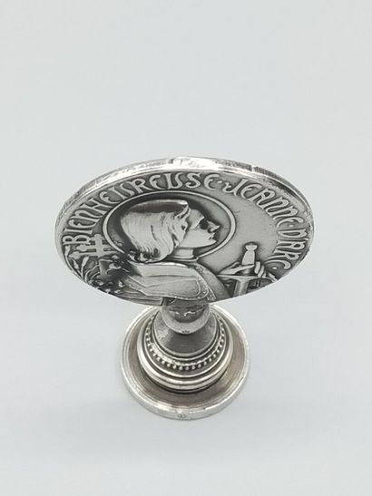 Silver seal representing Joan of Arc in armor...