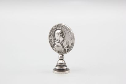 Silver seal representing Joan of Arc in armor...