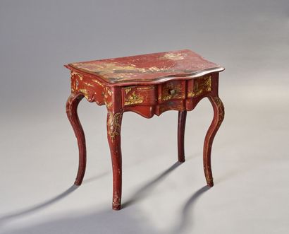 Carved and lacquered wood console on a red...