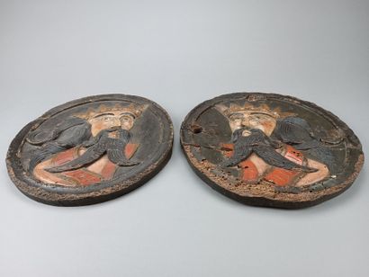 Pair of circular decorative elements in carved...