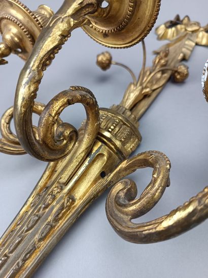 Pair of ormolu and chased sconces with three...