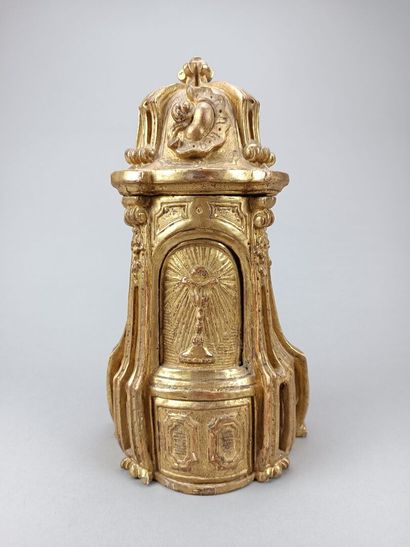 Curious reliquary in carved gilded wood.
Featuring...