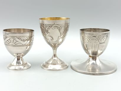 Three silver egg cups on foot with incised...