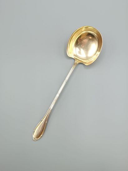 Louis XVI-style silver and vermeil soup ladle.
Decorated...
