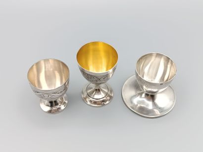 Three silver egg cups on foot with incised...