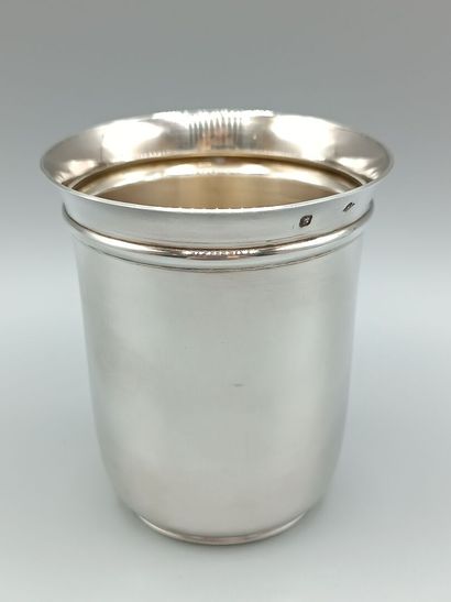 Plain silver tumbler, flared at the neck....