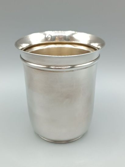 Plain silver tumbler, flared at the neck....