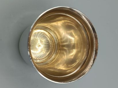 Plain silver tumbler, flared at the neck....