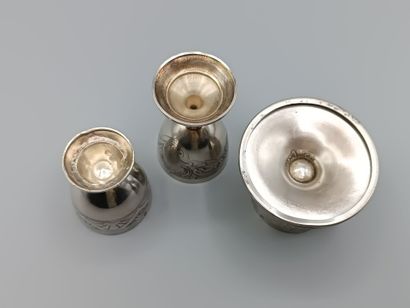 Three silver egg cups on foot with incised...