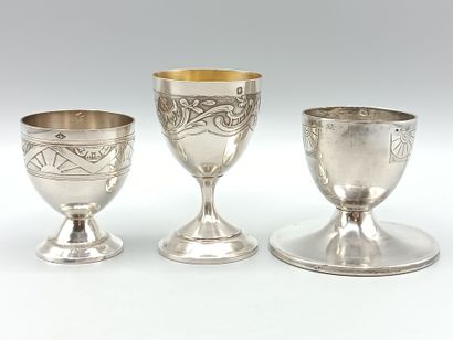 Three silver egg cups on foot with incised...