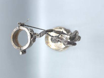 Bottle holder in cast and chased silver....