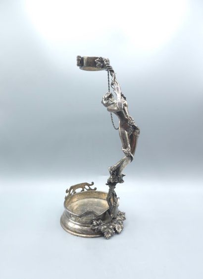 Bottle holder in cast and chased silver....