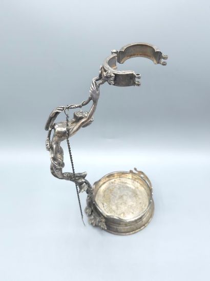 Bottle holder in cast and chased silver....