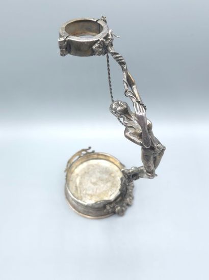 Bottle holder in cast and chased silver....