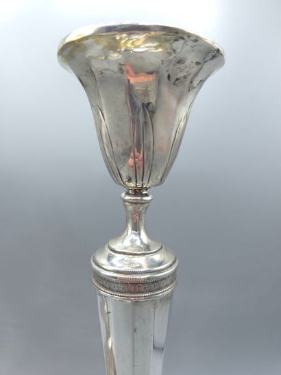 Pair of silver candlesticks.
The upper part...
