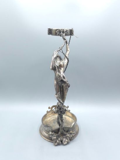 Bottle holder in cast and chased silver....