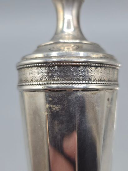 Pair of silver candlesticks.
The upper part...