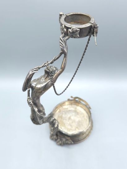Bottle holder in cast and chased silver....