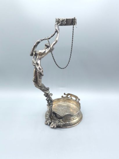 Bottle holder in cast and chased silver....