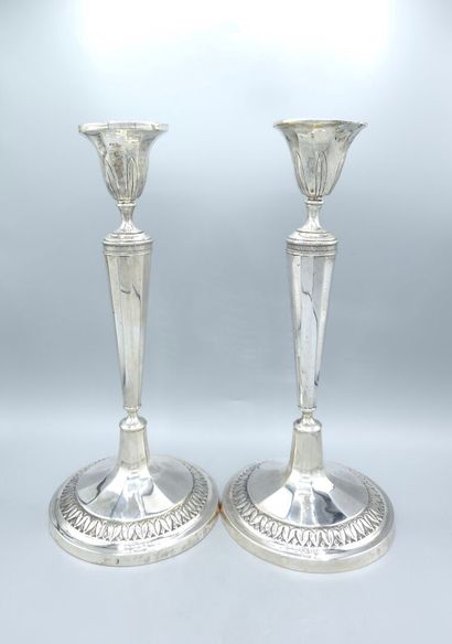 Pair of silver candlesticks.
The upper part...