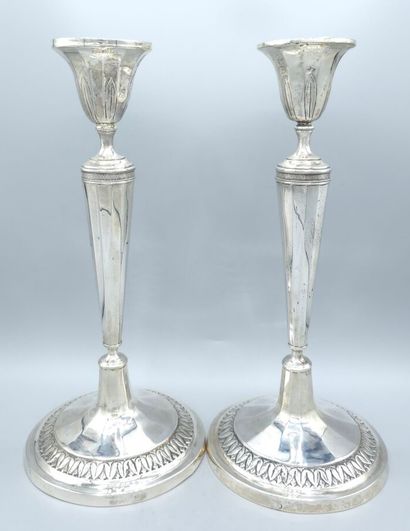 Pair of silver candlesticks.
The upper part...