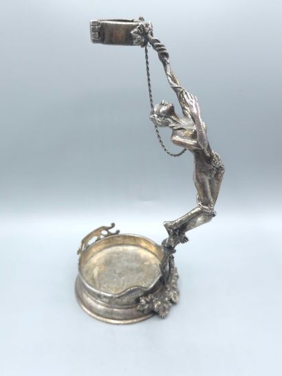 Bottle holder in cast and chased silver....