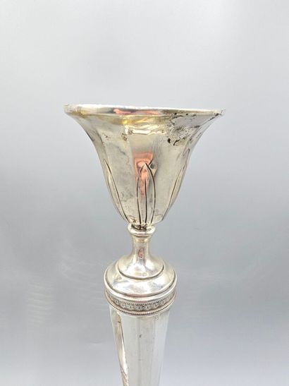 Pair of silver candlesticks.
The upper part...