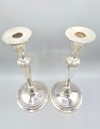 Pair of silver candlesticks.
The upper part...