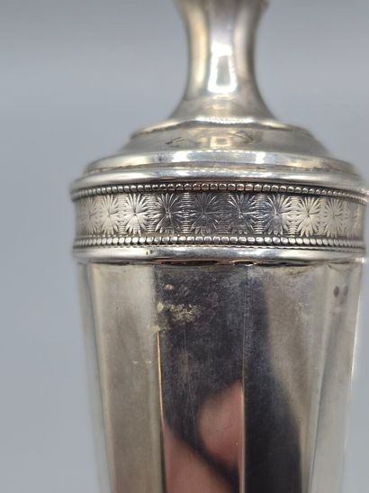 Pair of silver candlesticks.
The upper part...