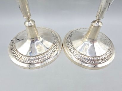 Pair of silver candlesticks.
The upper part...