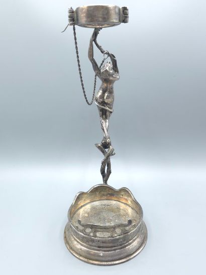 Bottle holder in cast and chased silver....