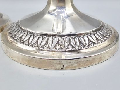 Pair of silver candlesticks.
The upper part...