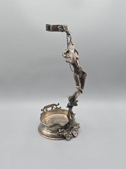Bottle holder in cast and chased silver....