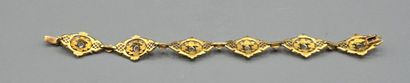 Bracelet articulé en or jaune 750°°.
Constitué...