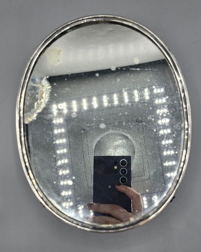Oval silver-plated metal display tray resting...