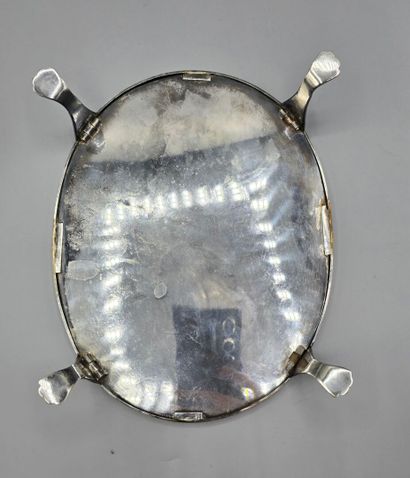 Oval silver-plated metal display tray resting...