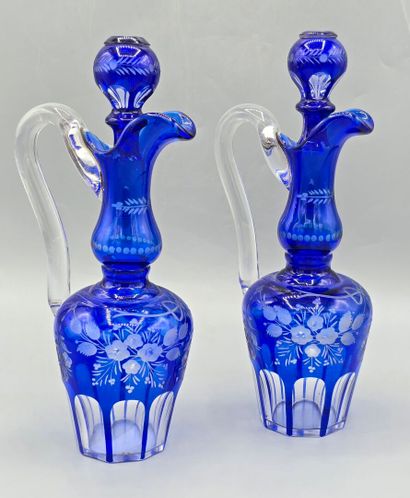 A pair of blue crystal decanters.
Two stoppers...