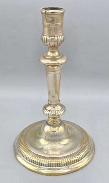 A silver-plated bronze candlestick with a...