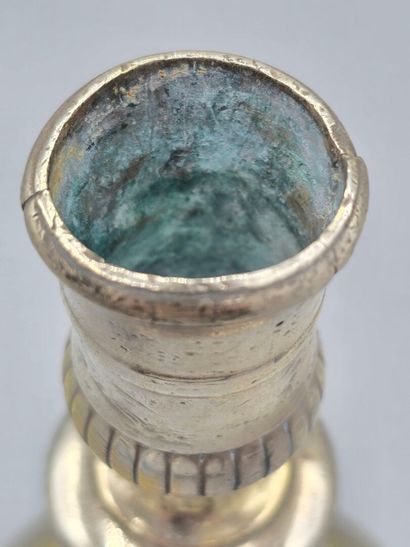 A silver-plated bronze candlestick with a...