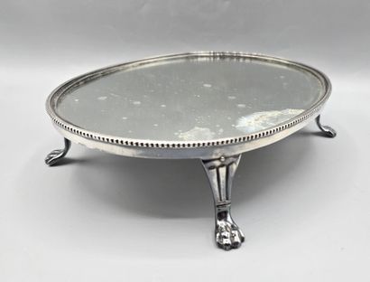 Oval silver-plated metal display tray resting...