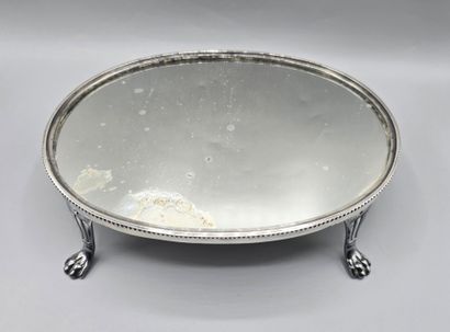 Oval silver-plated metal display tray resting...
