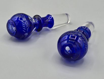 A pair of blue crystal decanters.
Two stoppers...