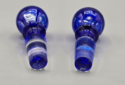 A pair of blue crystal decanters.
Two stoppers...