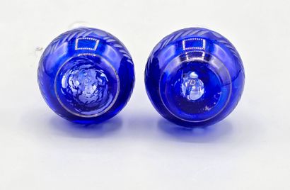 A pair of blue crystal decanters.
Two stoppers...