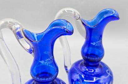 A pair of blue crystal decanters.
Two stoppers...