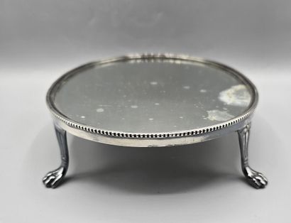 Oval silver-plated metal display tray resting...
