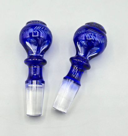 A pair of blue crystal decanters.
Two stoppers...