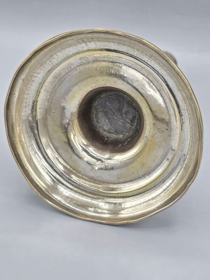 A silver-plated bronze candlestick with a...