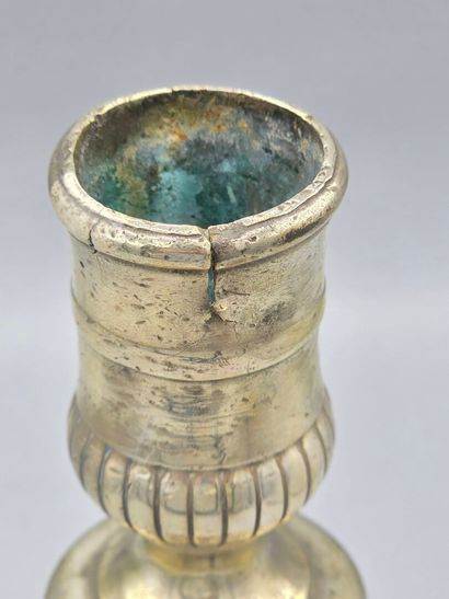A silver-plated bronze candlestick with a...
