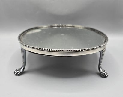 Oval silver-plated metal display tray resting...